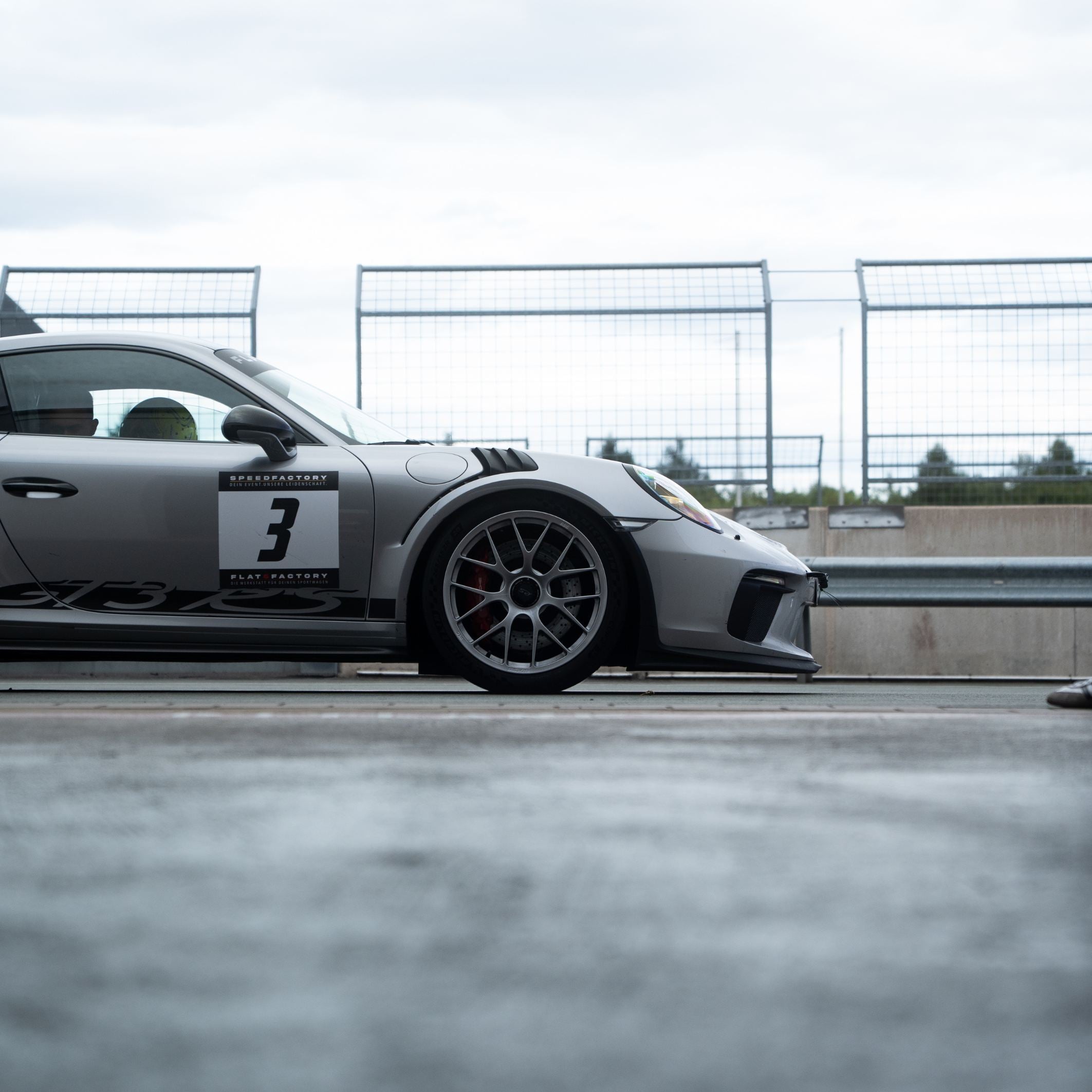Silberner Porsche GT3 RS auf der Rennstrecke